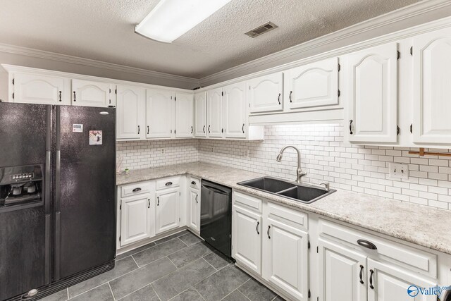 kitchen with white cabinets, dark tile patterned flooring, black appliances, and sink