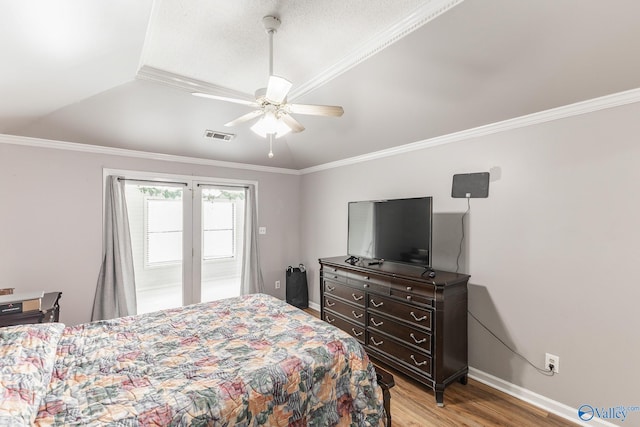 bedroom with vaulted ceiling, crown molding, light wood-type flooring, and ceiling fan