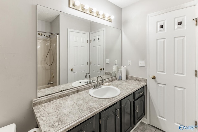 full bathroom featuring a textured ceiling, toilet, vanity, tile patterned floors, and bathing tub / shower combination
