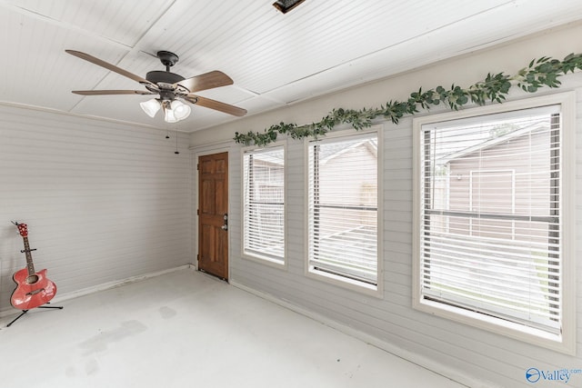 interior space featuring ceiling fan, a healthy amount of sunlight, and concrete floors