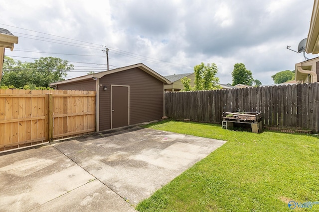 view of yard with a storage shed and a patio