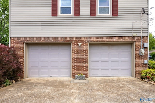 garage featuring concrete driveway