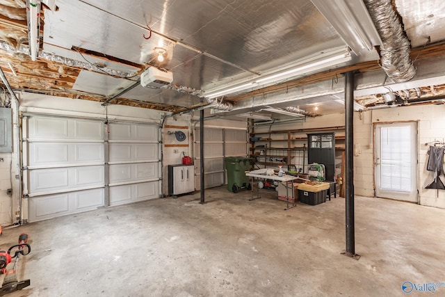 garage featuring a garage door opener and electric panel