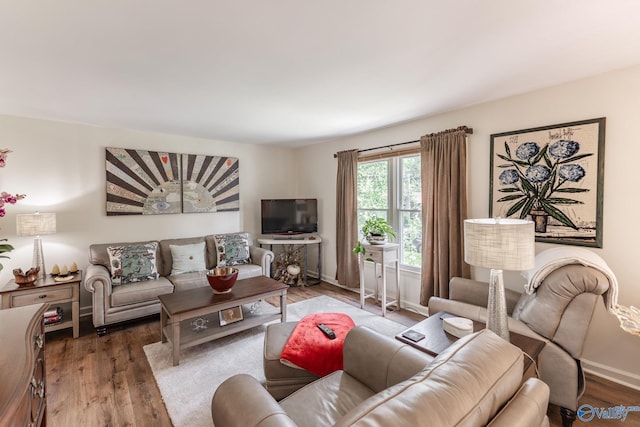 living room with baseboards and wood finished floors