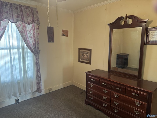 bedroom featuring baseboards, dark colored carpet, and ornamental molding