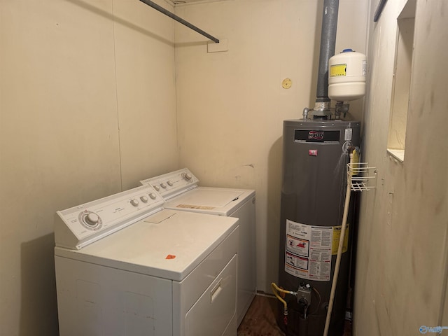 washroom featuring gas water heater, laundry area, and washing machine and clothes dryer