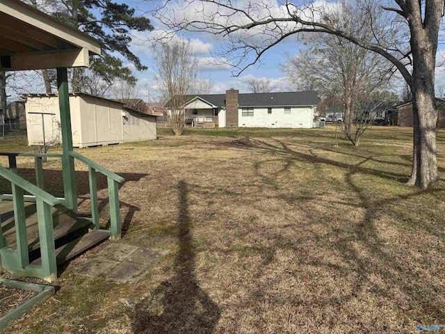 view of yard with an outbuilding and a storage shed