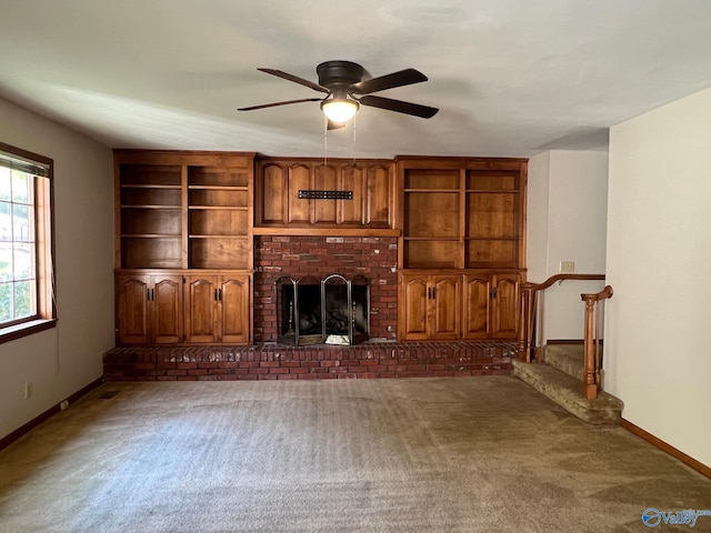 unfurnished living room featuring ceiling fan, dark carpet, and a fireplace