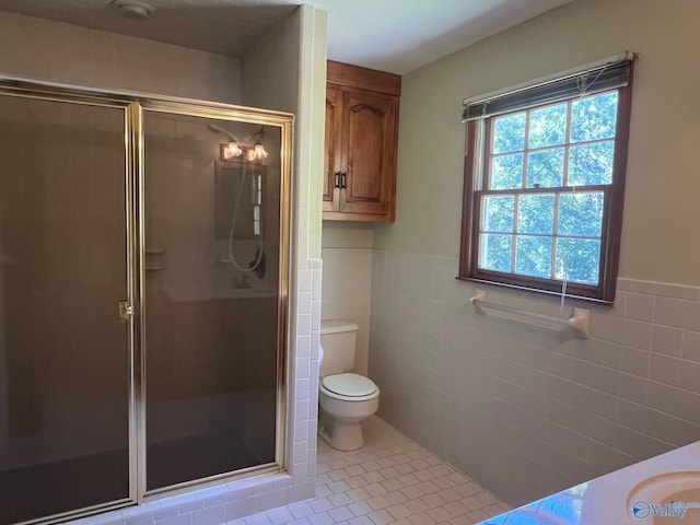 bathroom with toilet, an enclosed shower, and tile walls