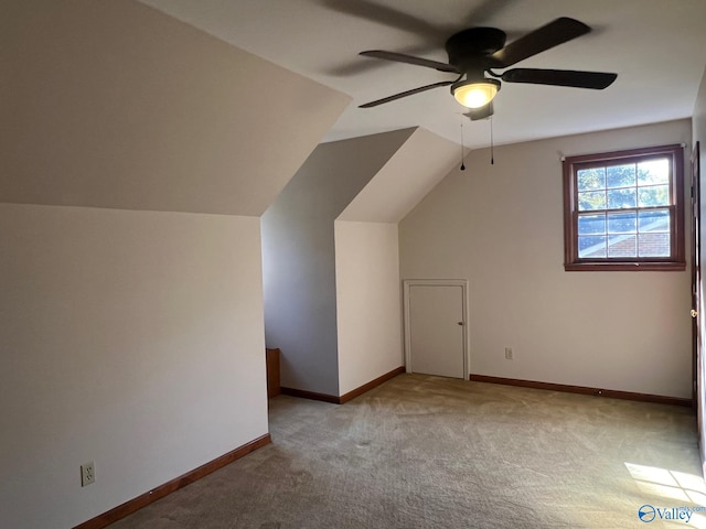 additional living space featuring lofted ceiling, light colored carpet, and ceiling fan