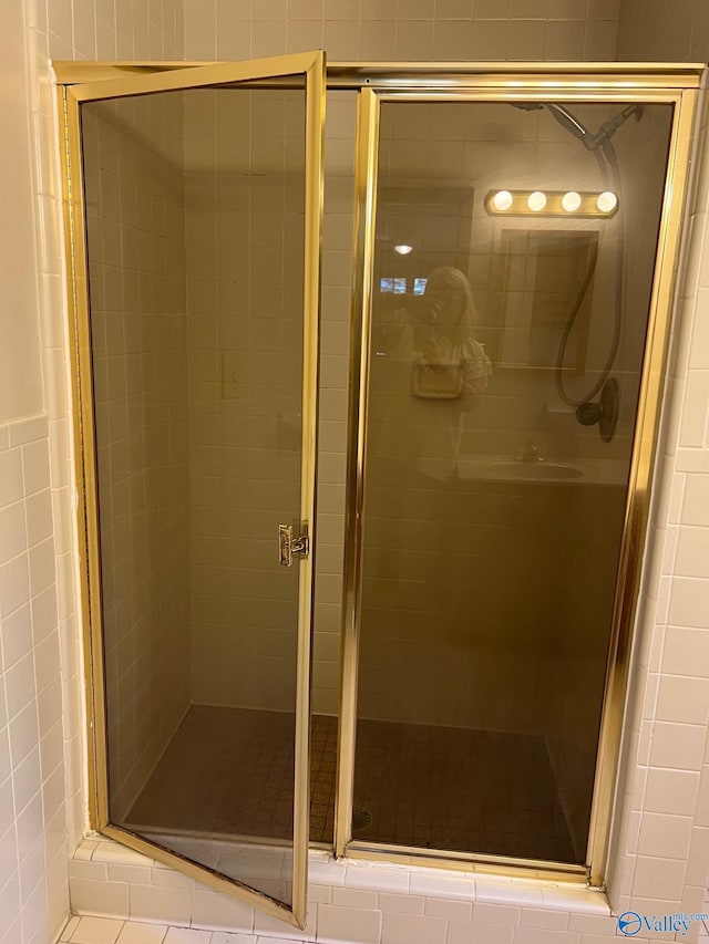 bathroom with a shower with door