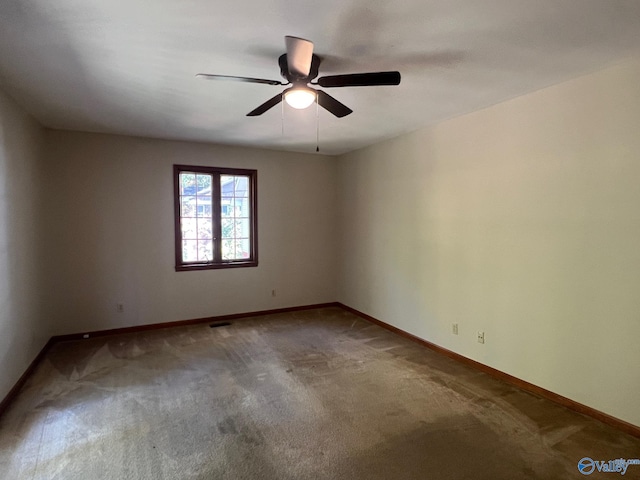 empty room with ceiling fan and carpet flooring