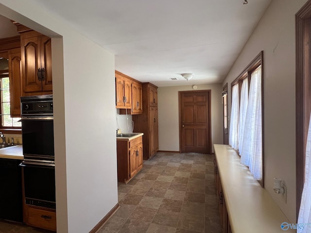 kitchen featuring double oven and sink