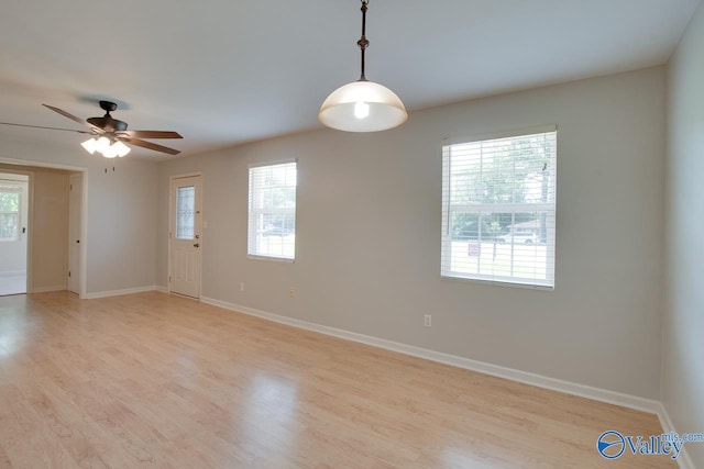 2404 Yorkshire Cir SW, Huntsville, AL 35803 - spare room featuring healthy amount of natural light, light wood-style floors, baseboards, and a ceiling fan