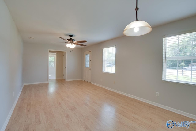 2404 Yorkshire Cir SW, Huntsville, AL 35803 - empty room with light wood-style flooring, a ceiling fan, and baseboards