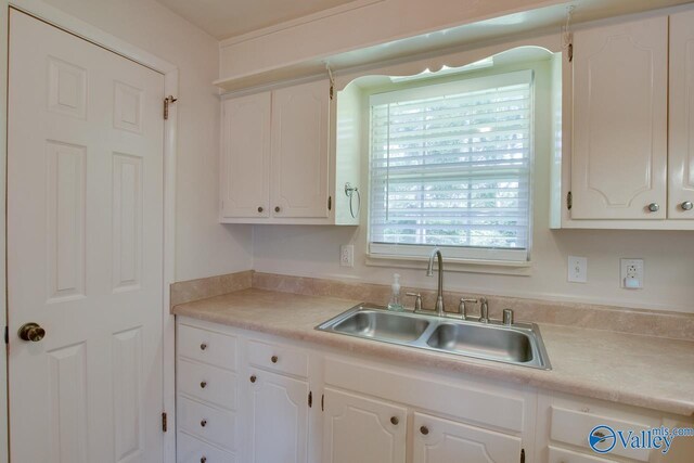 2404 Yorkshire Cir SW, Huntsville, AL 35803 - kitchen with a sink, white cabinetry, and light countertops
