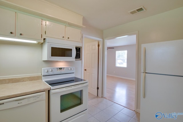 2404 Yorkshire Cir SW, Huntsville, AL 35803 - kitchen featuring white appliances, light tile patterned flooring, white cabinetry, and light countertops