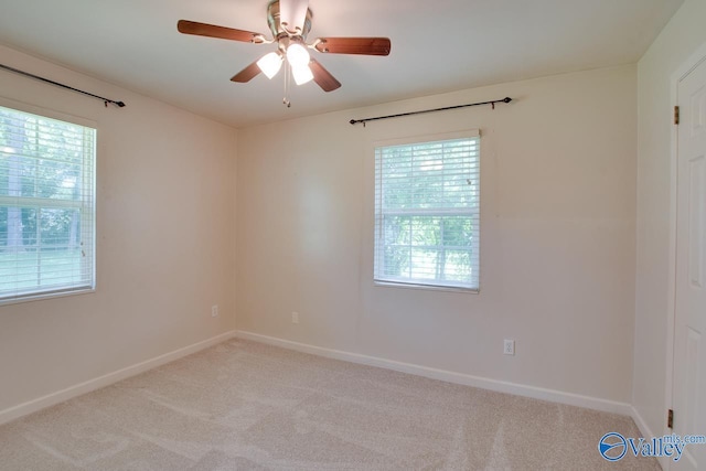 2404 Yorkshire Cir SW, Huntsville, AL 35803 - empty room with light carpet, healthy amount of natural light, a ceiling fan, and baseboards