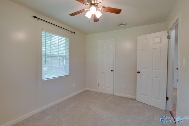 2404 Yorkshire Cir SW, Huntsville, AL 35803 - unfurnished bedroom with light carpet, baseboards, and a ceiling fan