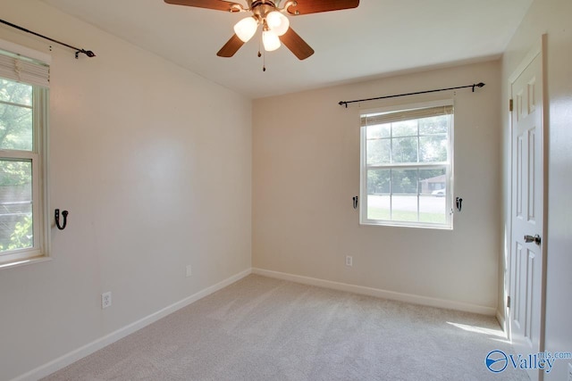 2404 Yorkshire Cir SW, Huntsville, AL 35803 - empty room with a ceiling fan, baseboards, and light carpet