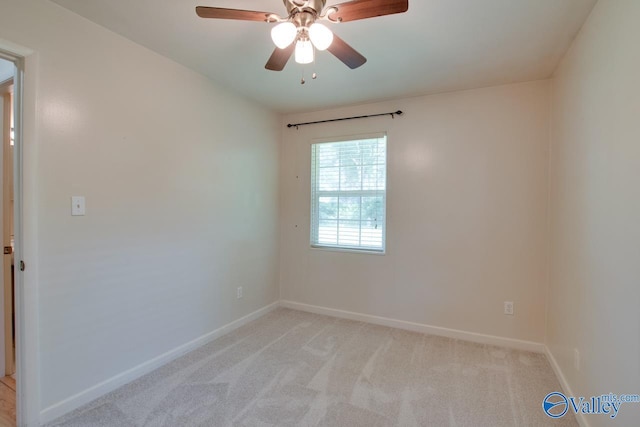 2404 Yorkshire Cir SW, Huntsville, AL 35803 - spare room with baseboards, light carpet, and a ceiling fan