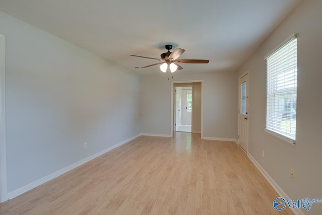 2404 Yorkshire Cir SW, Huntsville, AL 35803 - empty room with light wood finished floors, a ceiling fan, and baseboards
