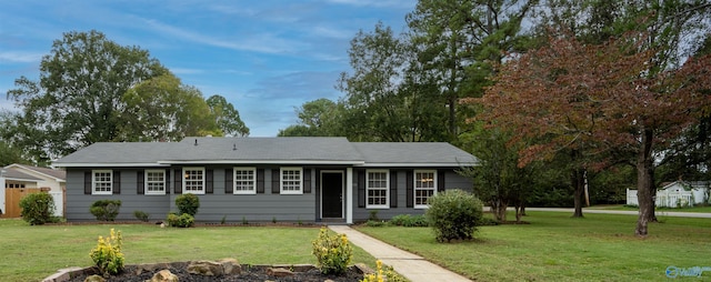 ranch-style home featuring a front yard