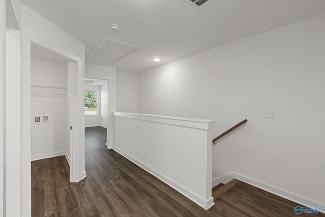 corridor with baseboards, an upstairs landing, dark wood-type flooring, and attic access