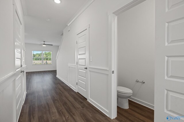 corridor featuring dark wood-style floors and baseboards