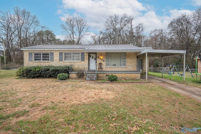 single story home featuring a carport, a porch, a playground, and a front yard