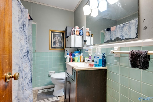 bathroom featuring vanity, ornamental molding, tile walls, and toilet