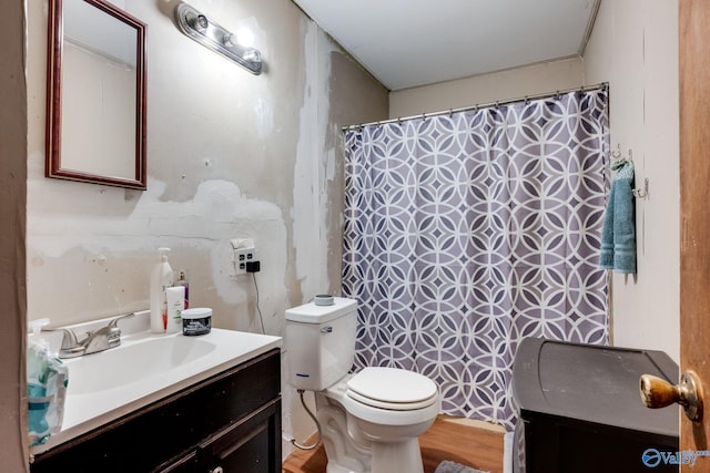 bathroom with vanity, hardwood / wood-style floors, and toilet