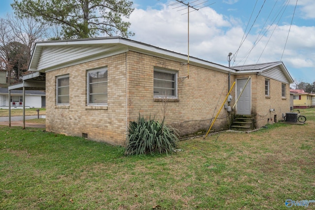 back of property featuring central AC unit and a lawn