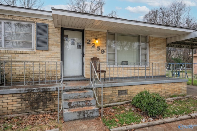 doorway to property featuring covered porch