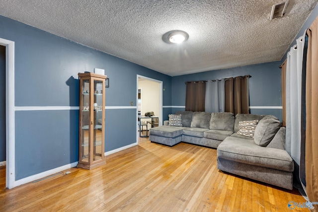 living room featuring hardwood / wood-style flooring and a textured ceiling