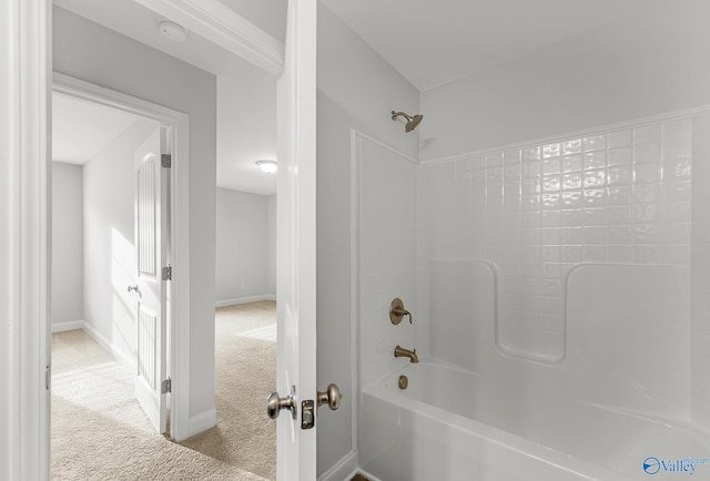 bathroom featuring shower / bathing tub combination and baseboards