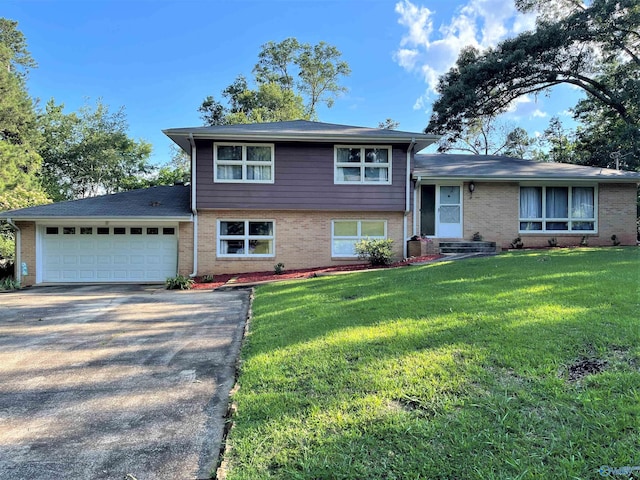 split level home featuring a front yard and a garage