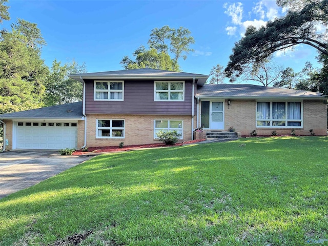 split level home with a front yard and a garage