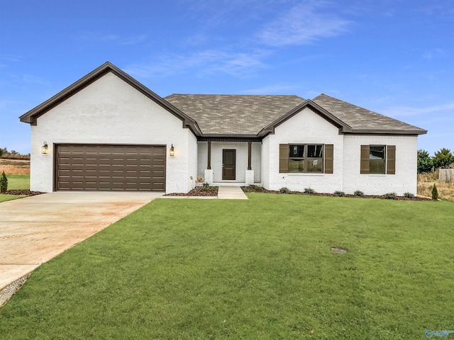 view of front of house featuring a garage and a front yard