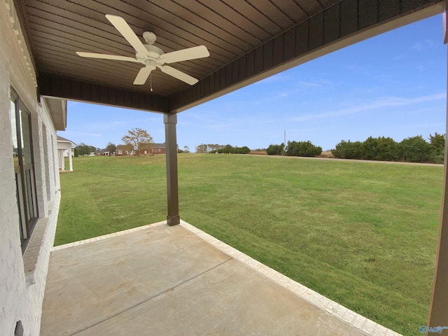 view of yard featuring ceiling fan and a patio