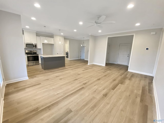 unfurnished living room featuring crown molding, ceiling fan, and light hardwood / wood-style flooring