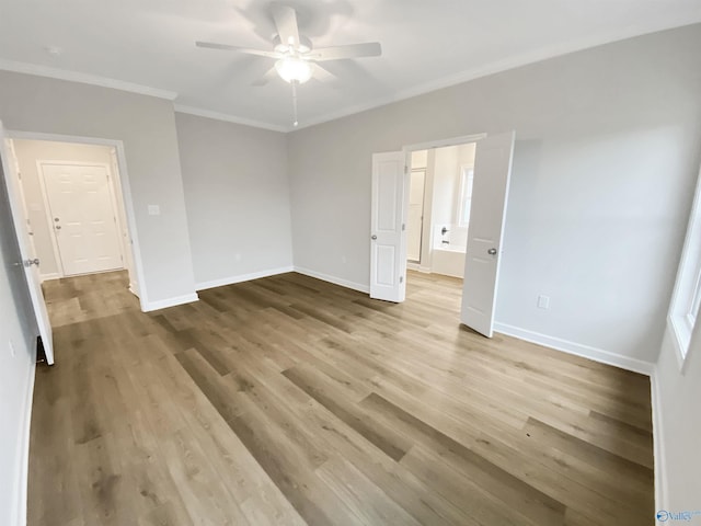 spare room featuring crown molding, light hardwood / wood-style flooring, and ceiling fan