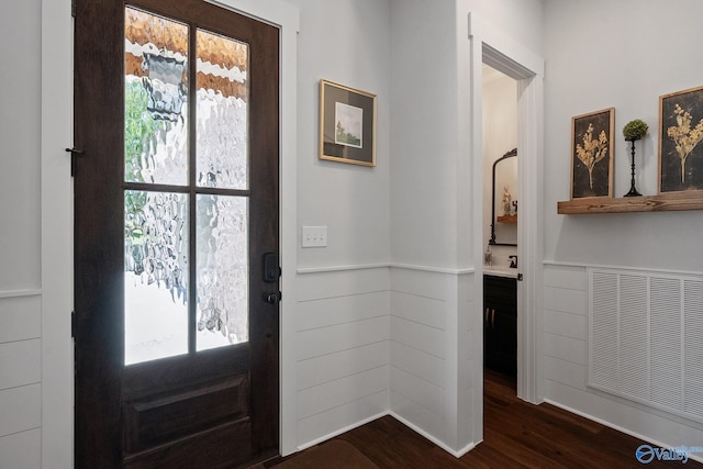 foyer entrance with a wealth of natural light and dark wood-type flooring