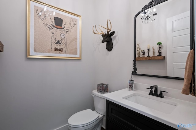 bathroom featuring vanity and toilet