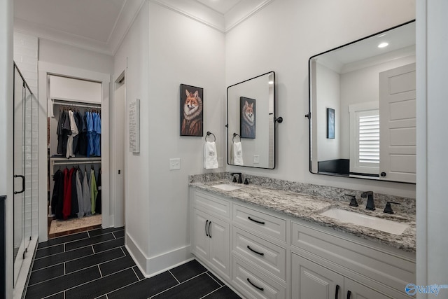 bathroom with vanity, crown molding, and a shower with door