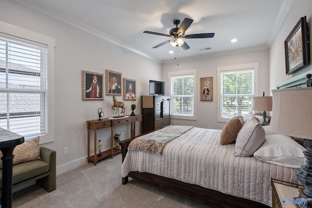 bedroom featuring ornamental molding, light colored carpet, and ceiling fan