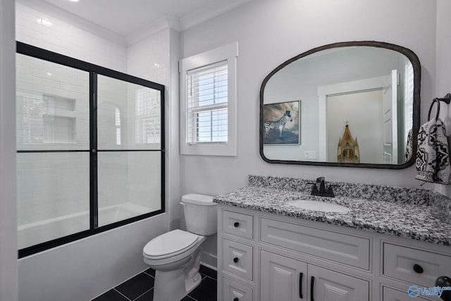 full bathroom featuring crown molding, shower / bath combination with glass door, vanity, tile patterned floors, and toilet