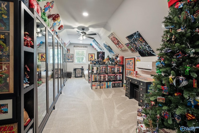 carpeted office space featuring vaulted ceiling and ceiling fan