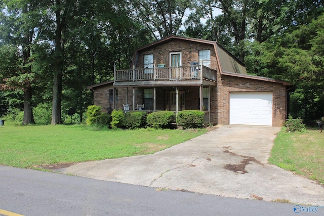 view of front of home with a gambrel roof, a front lawn, a garage, driveway, and brick siding