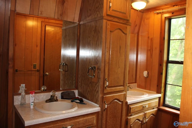 bathroom featuring vanity and wood walls